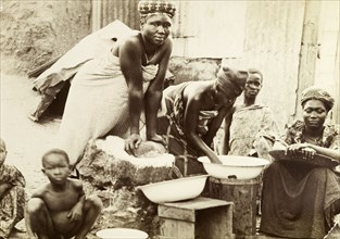 Making bread, Gold Coast. Gold Coast women making bread in a traditional manner. Salt Pond, Gold