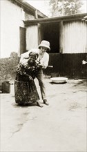 Mr Tamlin grappling. Mr Alfred Tamlin tickles an African woman. Western Africa, circa 1920.,