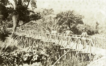 Timber bridge near Accra. Europeans and Africans pose for the camera on a timber bridge near Accra.