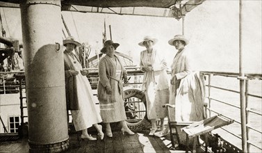 Onboard the 'Appam'. Four European women stand together on the deck of the 'Appam', a cargo and