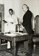 Nyerere takes an oath. Official publicity shot for the Tanganyikan government. Dr Julius Kambarage