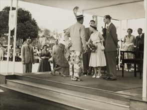 Queen Elizabeth meets a Nigerian chief. Queen Elizabeth II greets a Nigerian chief and his wife