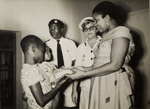 Staff meet patients at a British Red Cross Clinic. Staff meet patients at a Children's Welfare