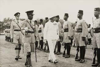 Inspection of the King's African Rifles. A European military officer, possibly a colonial Governor,