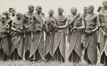 A group of Maasai women. A traditionally dressed group of young Maasai women stand in line. Their