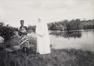 Mother Superior and student. The Mother Superior of the Chilabula Mission, dressed in white from
