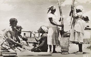 A domestic scene. Domestic scene showing a group of women working together outdoors in an African