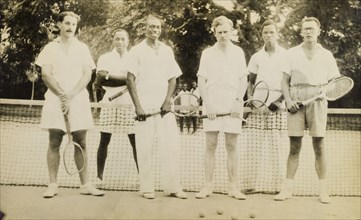 Mixed trebles. Six British and Nigerian men pose for the camera holding tennis racquets during a