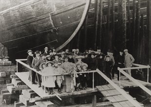 Henry Bell Wortley at a dockyard. A group of formally dressed adults and children stand on a
