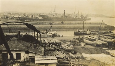 Mazapon Dock, Bombay. View of Mazapon Dock, showing a steamship and fishing trawlers at harbour.