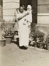 Ayah with baby. Outdoors portrait of an Indian ayah (nursemaid) with a British baby. India, circa