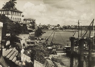 Mombasa Old Port, 1950. View across Mombasa's Old Port showing tradesmen unloading crates from