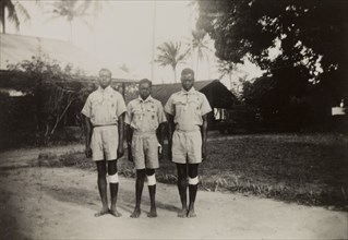 Three Kenyan scouts. Three Kenyan scouts pose for the camera outdoors at an inspection of scouts