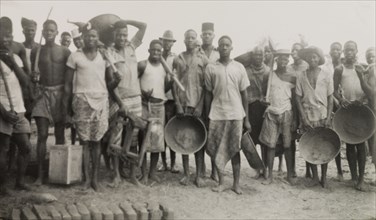 Builders of a new boys' school on the Tana River. A number of young Kenyan men, involved in