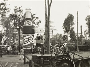Pepsi Cola' at the Royal Show. A giant 'Pepsi Cola' bottle advertises the drink to passsers-by at