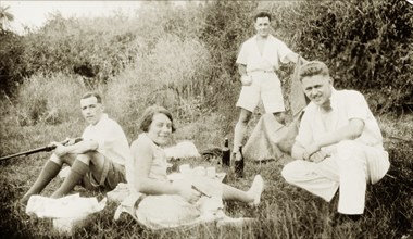 Dr Greta Lowe-Jellicoe enjoys a picnic. Three European men identified as 'Staunton, Ridley and