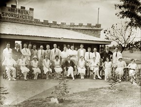 Members of the Abeokuta Sports Club. A number of European men and women line up for a group