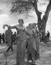Female Maasai dancers. Two young Maasai women wearing traditional dress and ornate jewellery pause