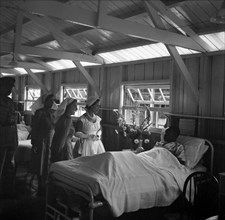 Princess Margaret at a British Military Hospital. Princess Margaret visits the bedside of a young