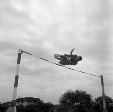 Joseph Lenesae jumps the bar. Kenyan high jumper Joseph Lenesae is captured in mid-air as he