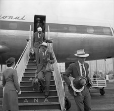 Athletes arrive in Australia. Athletes in the 1956 Kenyan Olympic team descend the steps of an
