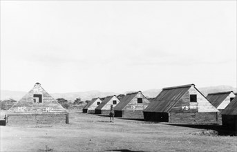 Home Guard living quarters. Numbered prefabricated huts form temporary accommodation for Kikuyu
