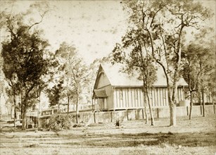 A temporary church at Indooroopilly. A makeshift wooden building with a pitched roof serves as a