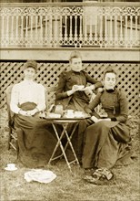 Katie, Prue and Ellie take tea, Australia. Members of the Brodribb family relax, looking