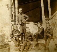 Five boys on the steps at 'Nundora'. Five boys connected with the Brodribb family pose with a dog
