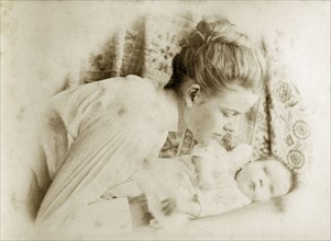 Ellen May Pughe and baby, Australia. Portrait of Ellen May Pughe leaning over her baby, one of her