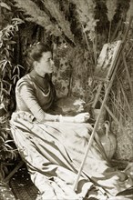 At the easel, Australia. Outdoors portrait of Ellen May Pughe, nee Brodribb, paused thoughtfully in