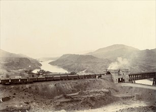 Freight train crossing the Indus River. A freight train crosses the iron girder bridge at Attock
