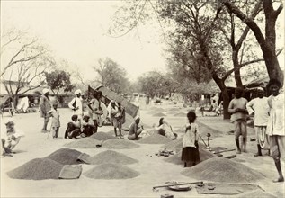 Indian grain market. Street traders at an Indian grain market mill about, their supplies of grain