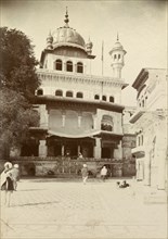 A Sikh temple at Lahore. Exterior view of a Sikh temple featuring decorative domes, turrets and