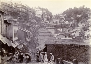Bustling market street at Murree. Shop awnings line a bustling market street that winds down from