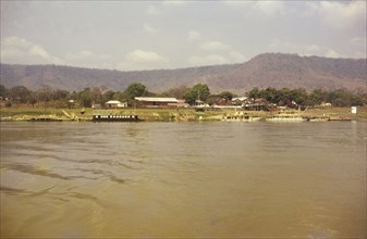 Lokoja trading houses. View across the river of ferries docked beside the Royal Niger Company
