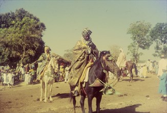 Celebrating the end of Ramadan. Men in traditional dress on horseback at a celebration marking the