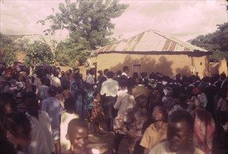 Nigerian outreach procession. A Church of Nigeria congregation from Asi gathers outdoors for an