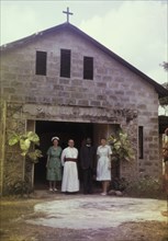 Archbishop visits a hospital chapel. Staff at a Church of Nigeria hospital stand at the doorway of