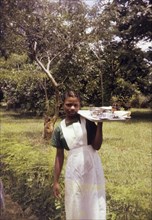 Training midwife, Nigeria. Outdoors portrait of a young woman training to become a midwife for a