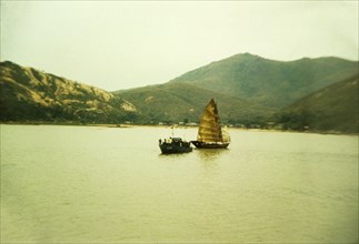 Chinese gun boat. A Chinese gun boat off the coast of Macau sails alongside a traditional Chinese