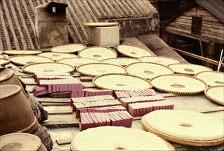 Noodles drying in the sun. Rings of noodles laid out to dry in the sun in flat baskets on a rooftop
