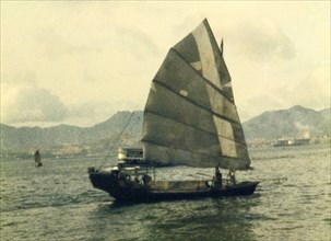 A Chinese junk. A Chinese junk sails off the coastline of Hong Kong. Hong Kong, People's Republic