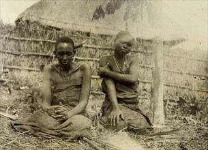 Sufferers from sleeping sickness, Uganda. A man and a woman dressed in bark cloth are seated
