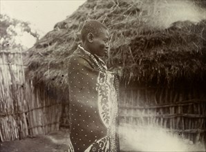 Ugandan woman. Profile shot of a Ugandan woman wrapped in a patterned cloth. Uganda, 1906. Uganda,