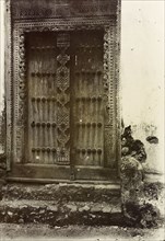 Ornate doorway, Zanzibar. An ornately carved wooden door in Zanzibar. Zanzibar (Tanzania), 1906.