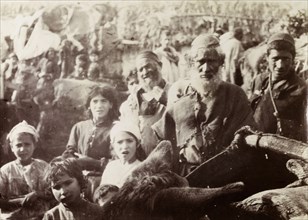 People at the 'mellah'. Informal portrait of men and children at a 'mellah' being held in the