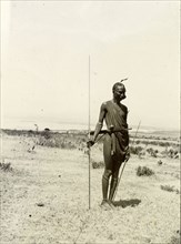 Maasai warrior. Full-length portrait of a Maasai warrior, spear in hand. British East Africa