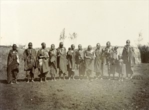 Maasai adults and children. A group of Maasai adults and children wearing traditional dress and