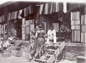 Indian shop, Nairobi. An Indian trader sits in the open doorway of his store, chatting to two
